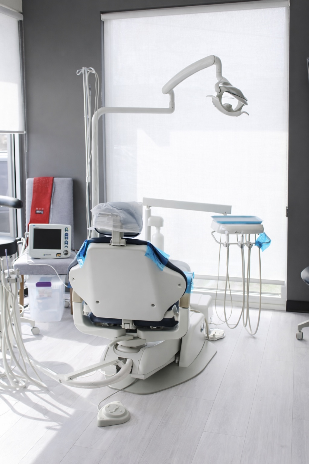 Relaxed patient smiling in a dental chair while talking with a dentist